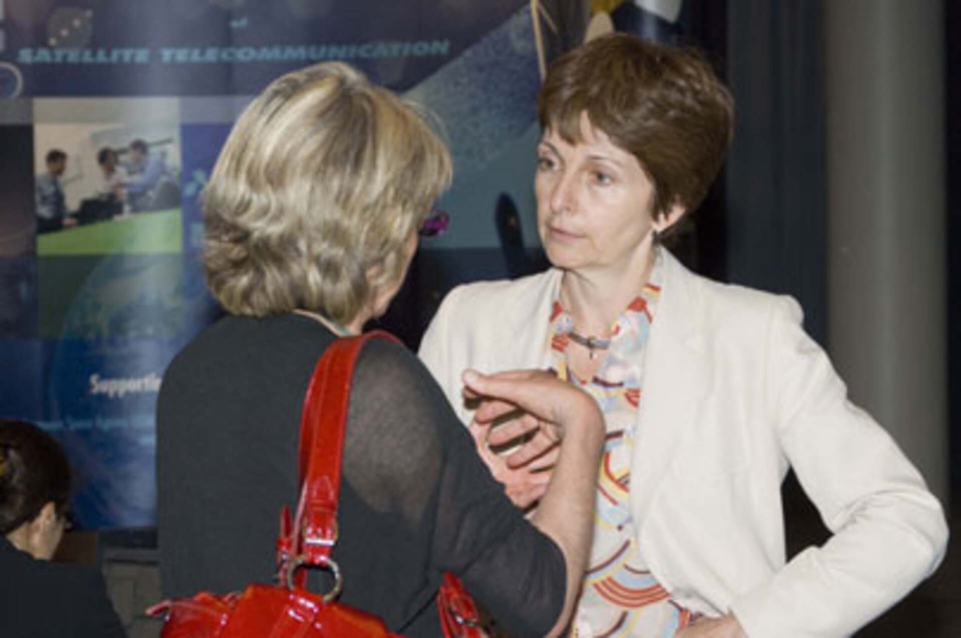 Magali Vaissiere, ESA's Director of TIA, talks with an Info Days attendee.