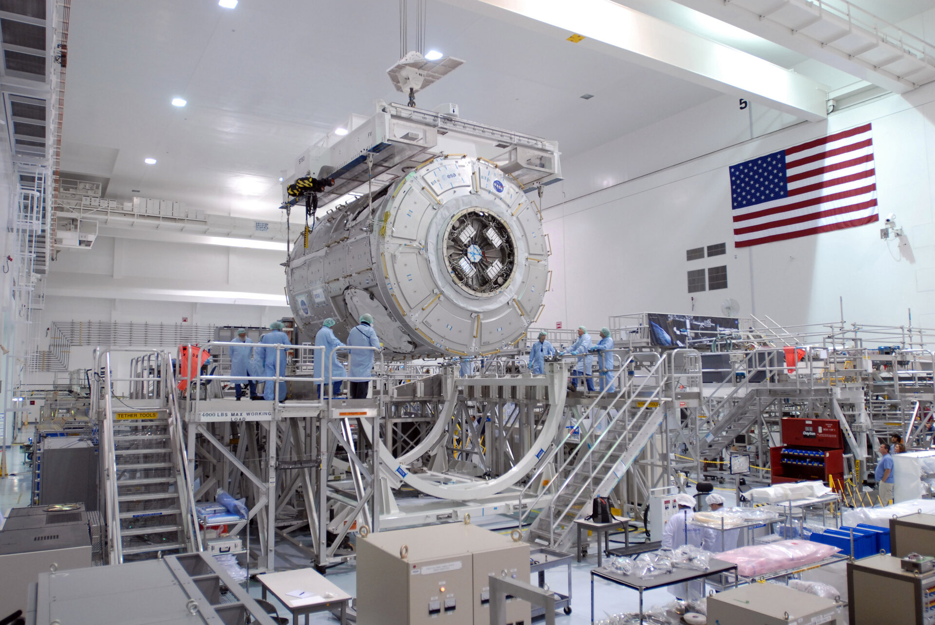 Node 3 is lowered towards a work stand in the Space Station Processing Facility at KSC