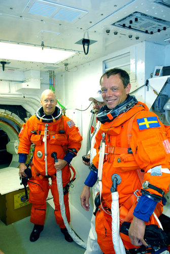 Forrester and Fuglesang wait to enter Discovery for the launch dress rehearsal