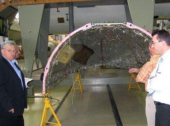 Team members viewing the fairing half-shell