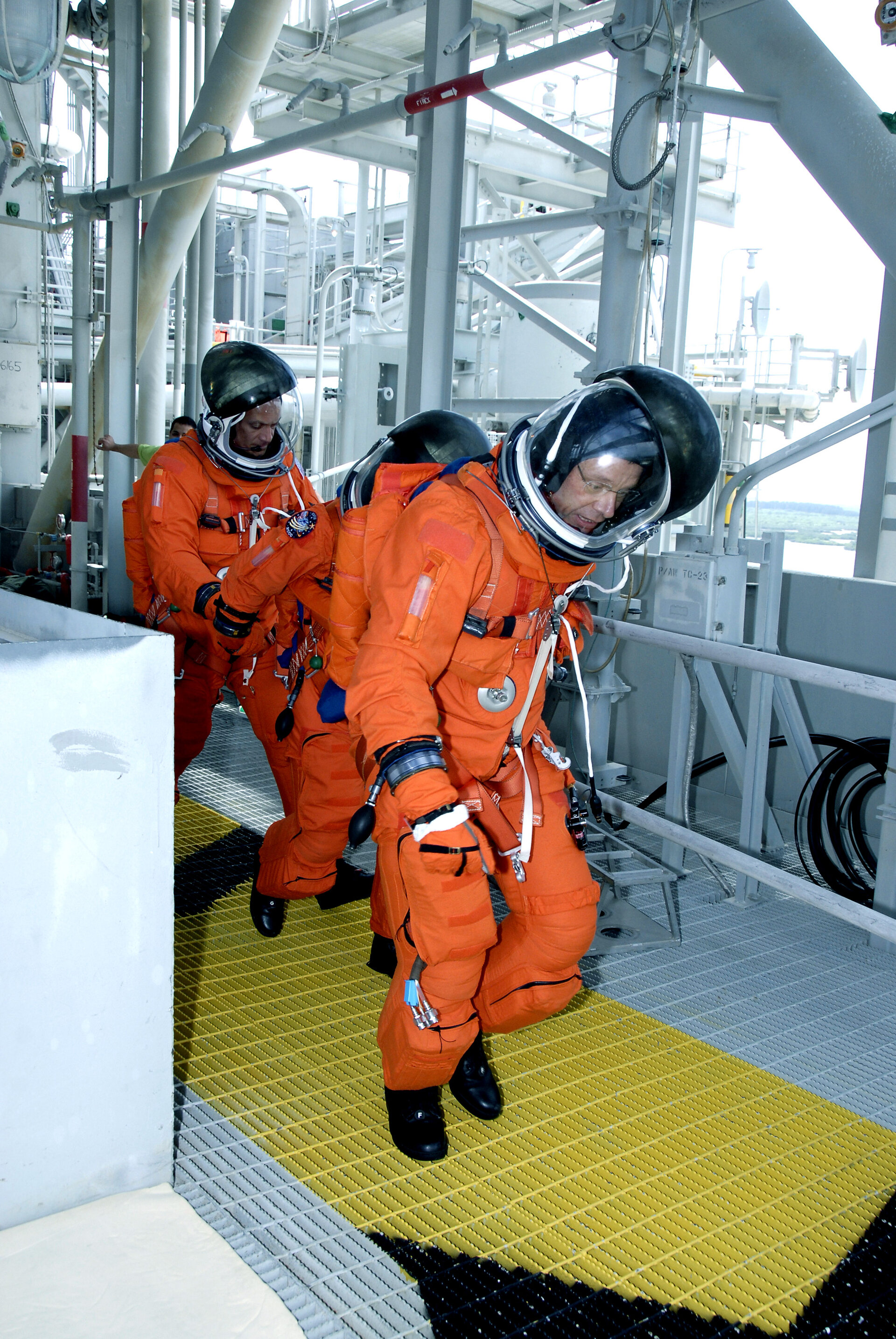 The STS-128 crew practice an emergency exit from the launch pad