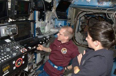 Frank De Winne and Nicole Stott with Canadarm 2 workstation