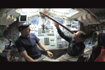 Astronauts Scott Altman and Michael Massimino use a replica of Galileo's telescope to observe space