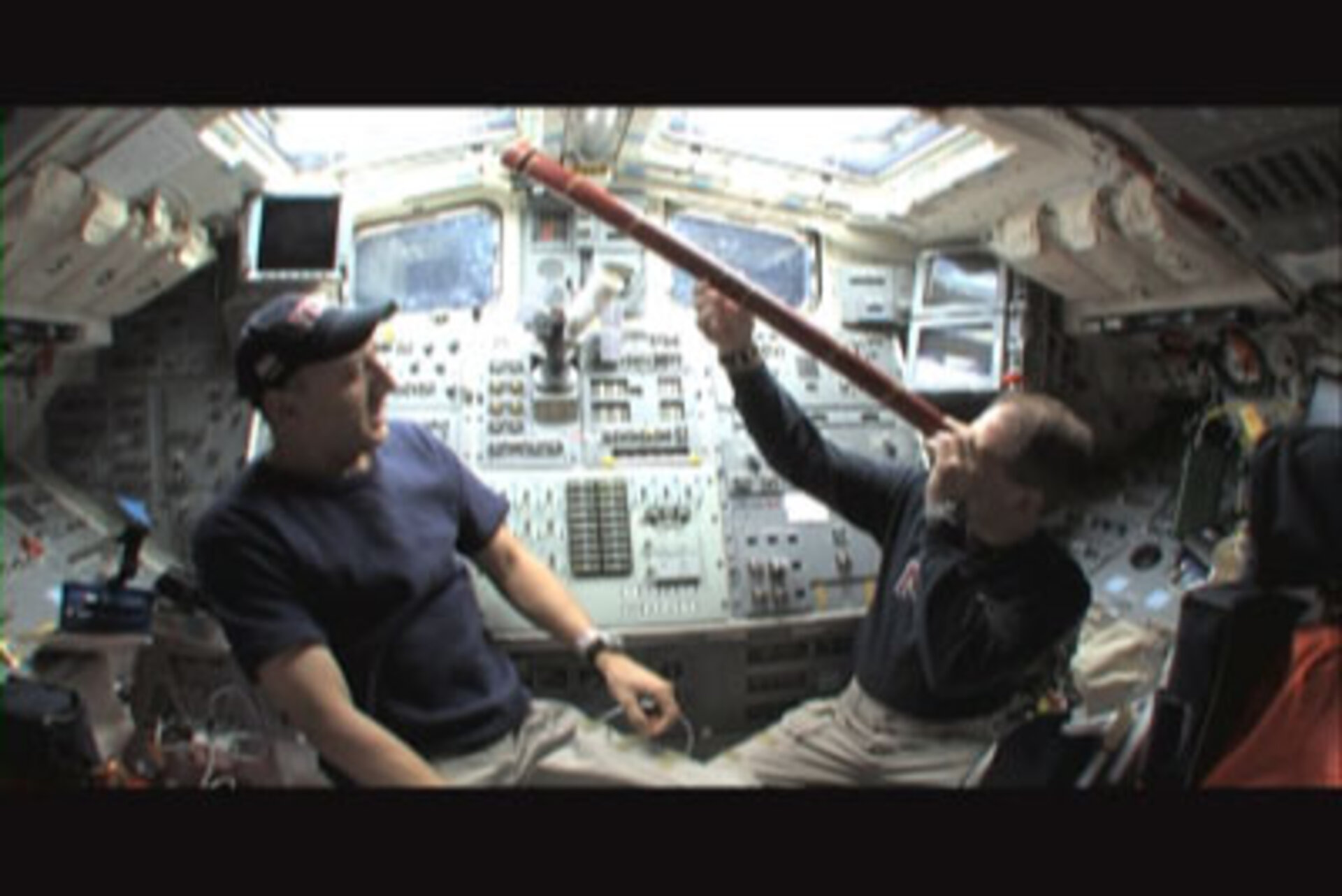 Astronauts Scott Altman and Michael Massimino use a replica of Galileo's telescope to observe space