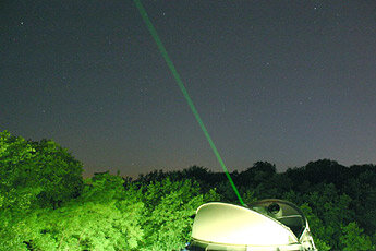 Laser ranging station aims at satellite