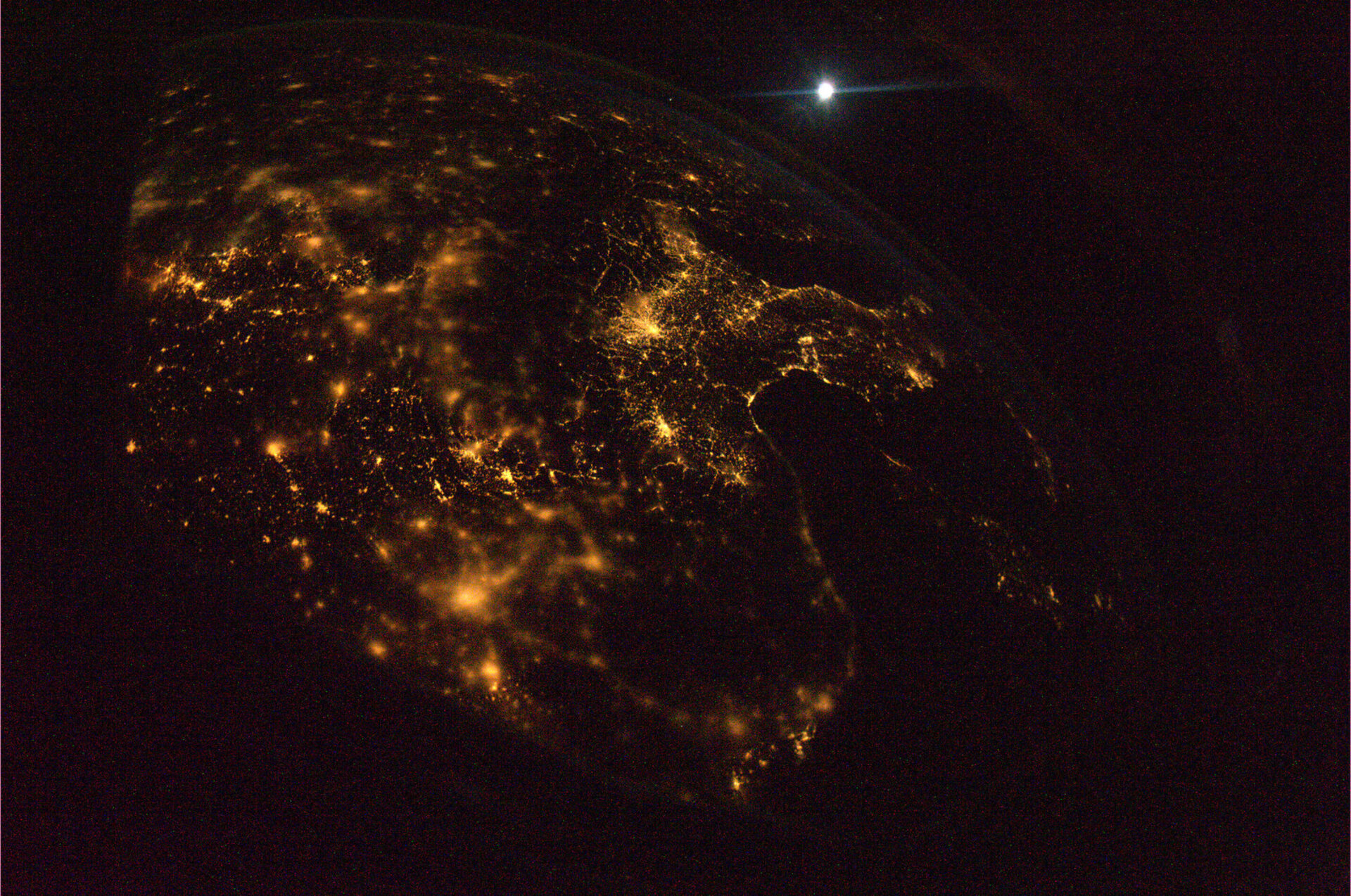 From over France, looking south, under the Moon