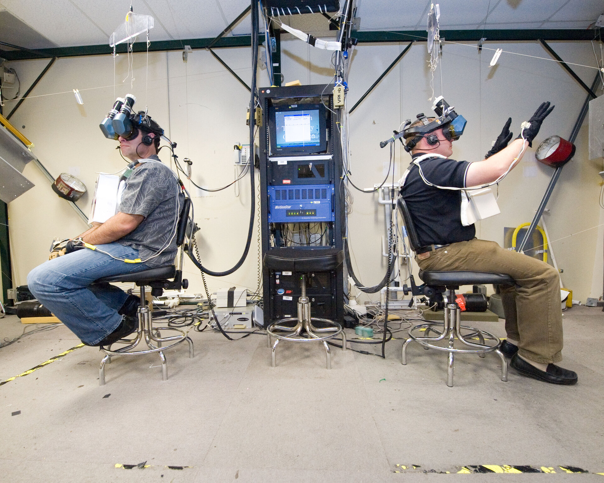 Michael Fincke and Greg Chamitoff use virtual reality hardware