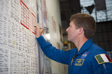 Vittori signing the space shuttle wall tribute