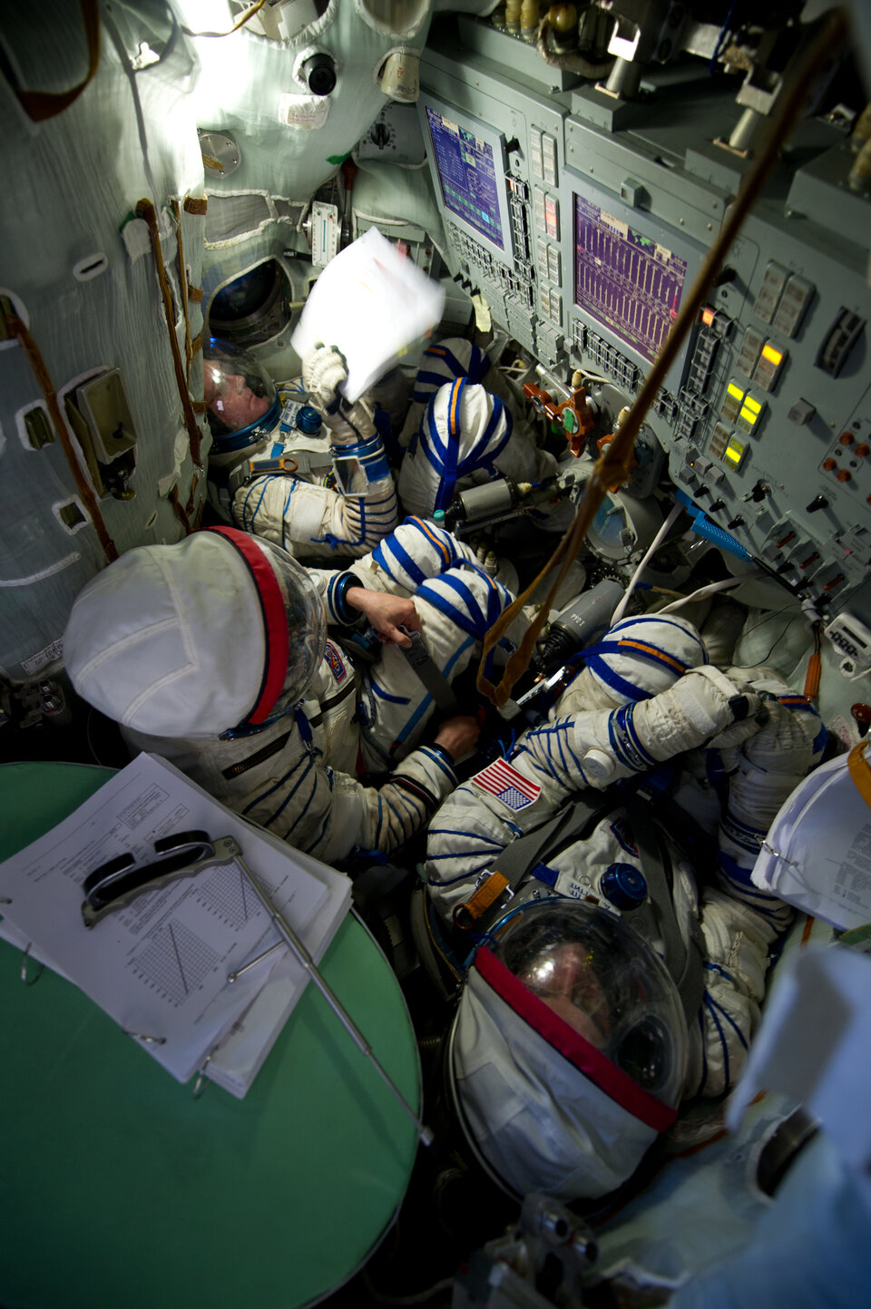 Inside a Soyuz TMA simulator, now without the masks (from left: André, Oleg and Don).