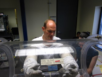 Alexander Gerst in spacesuit glove fit check