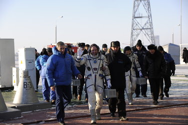 Expeditions 30 and 31 crew members prepare to take the elevator to the top of the Soyuz rocket