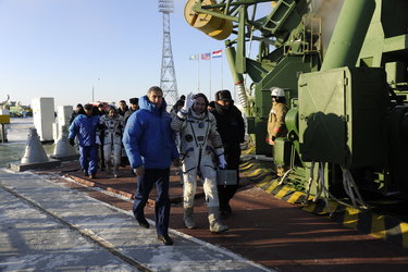 Expeditions 30 and 31 crew members prepare to take the elevator to the top of the Soyuz rocket