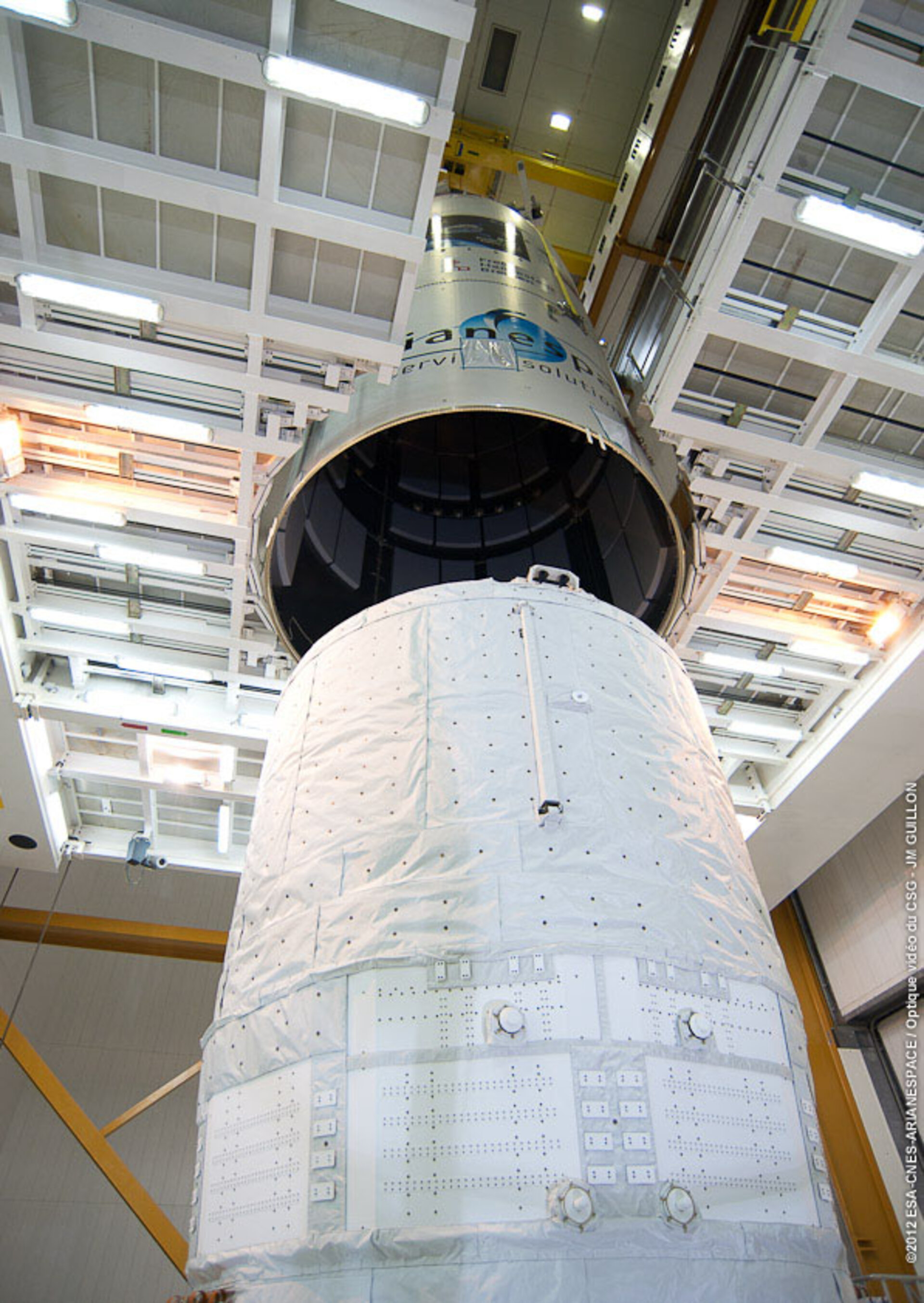 Ariane 5 fairing slowly being lowered over ATV-3