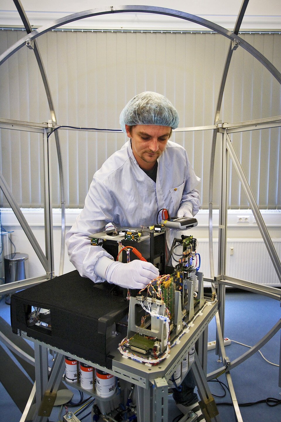 Engineer at work on satellite test bed