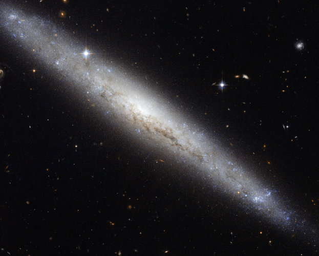 Hubble portrays a dusty spiral galaxy