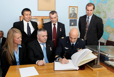 Luca Parmitano signs a commemorative book at the Cosmonautics Museum 