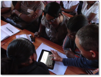 Teachers learning to use tablet computer