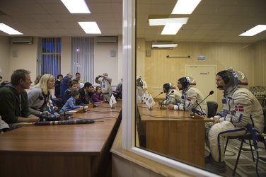 Soyuz TMA-18M crew members talking to gathered friends, family and dignitaries