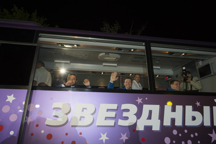 Soyuz TMA-18M crew members wave farewell to family and friends