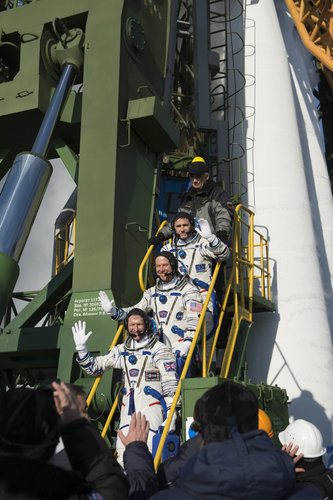 Soyuz TMA-19M crew members greeting audience at the launch pad