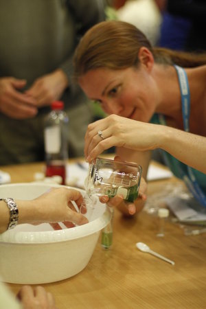 Teacher performing experiment with spirulina cells 