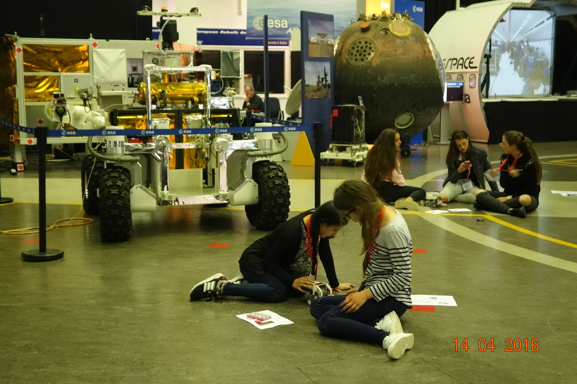 Groups of students work out how to code their robots