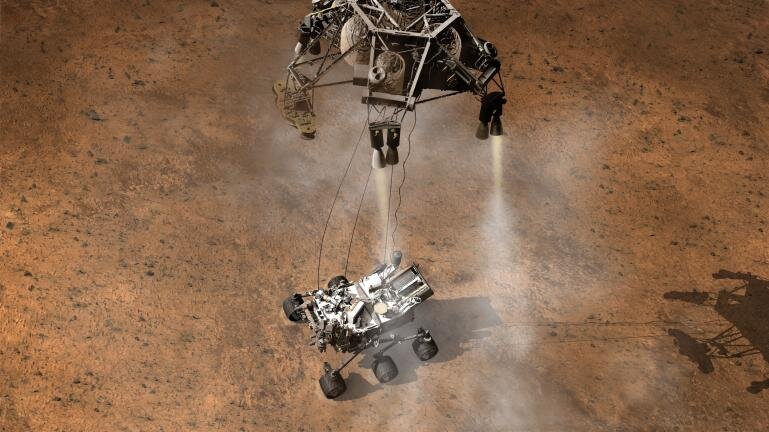 Aterrizaje del robot Curiosity, por debajo de la etapa de descenso que funcionó como grúa. Créditos: NASA/JPL-Caltech