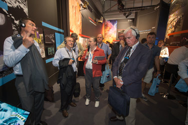 Isabelle Duvaux-Béchon shows AA-IHEDN representives the ESA Pavilion