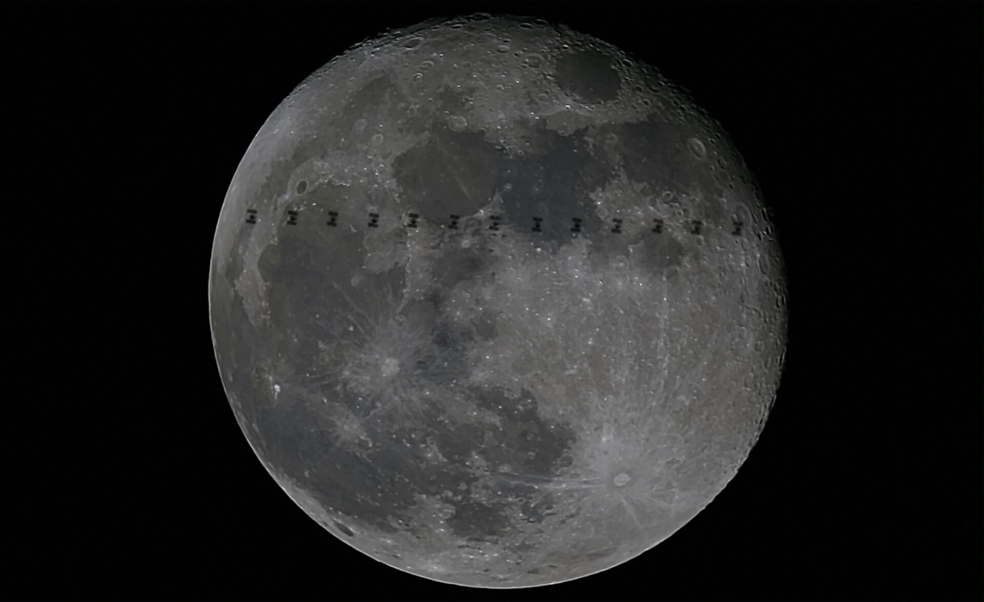 The International Space Station crosses the Moon