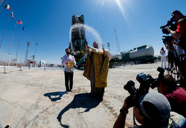 An Orthodox Priest blesses members of the media 