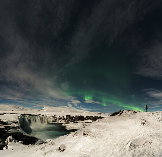 Rainbow over Iceland's Lake Mývatn under aurora