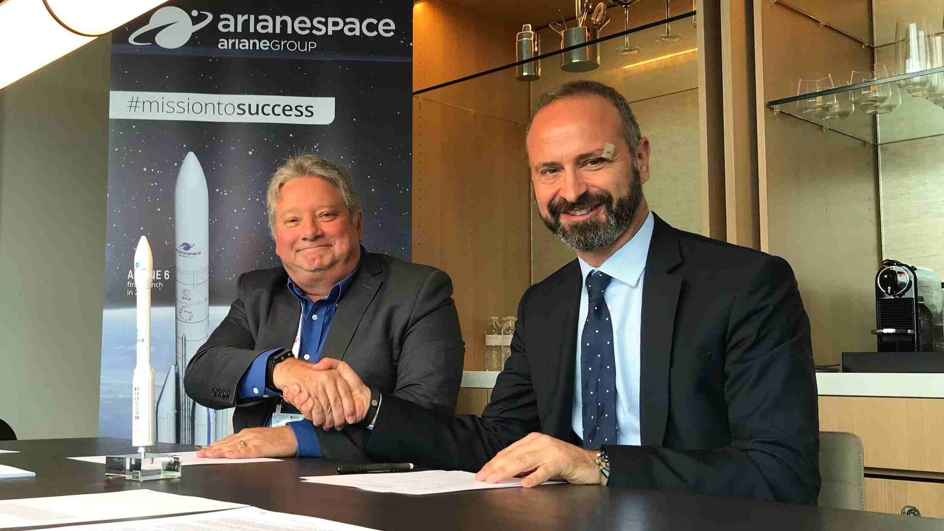 Peter Mabson of exactEarth (left) and Geoffroy Legros of Arianespace sign the launch contract for ESAIL