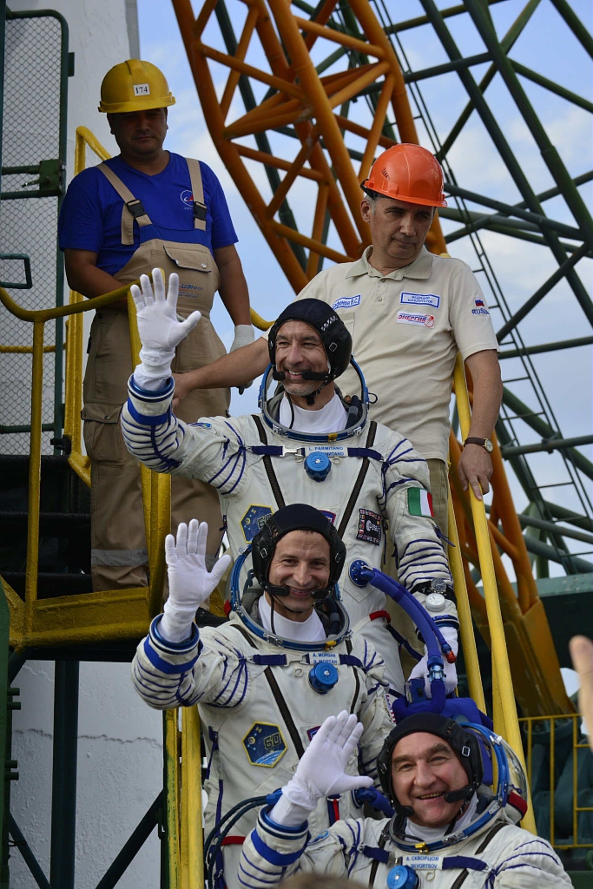 Soyuz MS-13 crew wave from the steps to their Soyuz MS-13 spacecraft