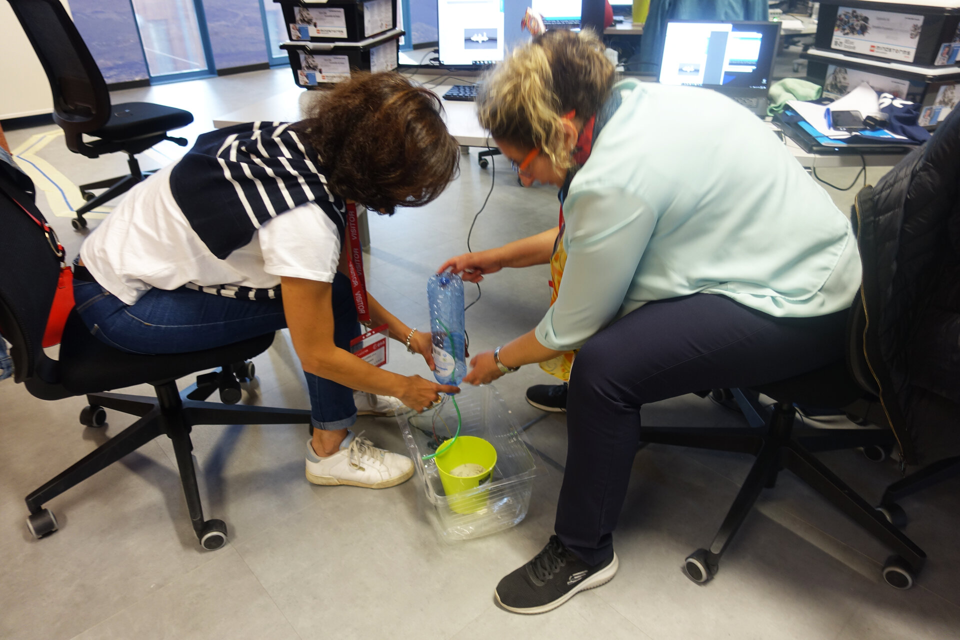 Secondary school teachers constructing an irrigation system for plants on Mars