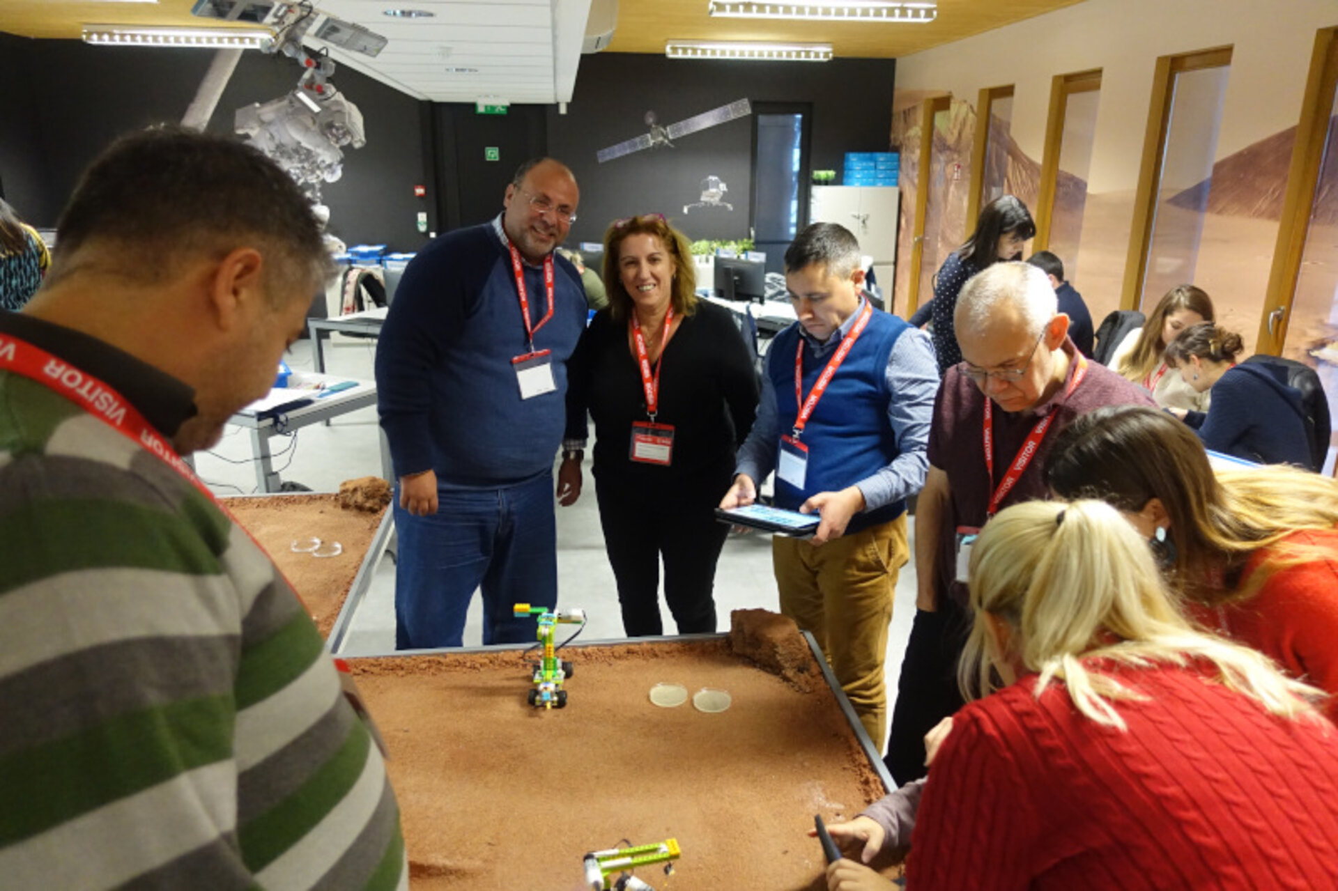 Teachers testing the acidity of a liquid sample found on the surface of Mars. 