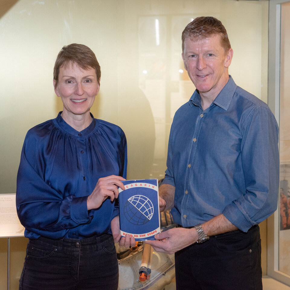British astronauts Helen Sharman and Tim Peake with the book that has twice flown into space