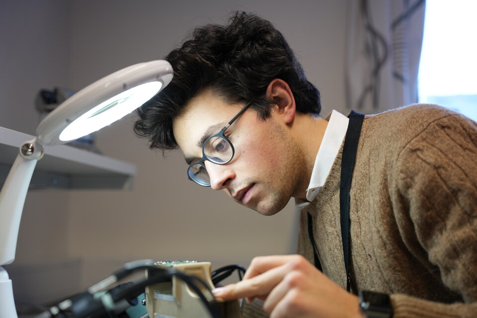 A student of the Sensor Experiments section preparing a sensor for the student rocket