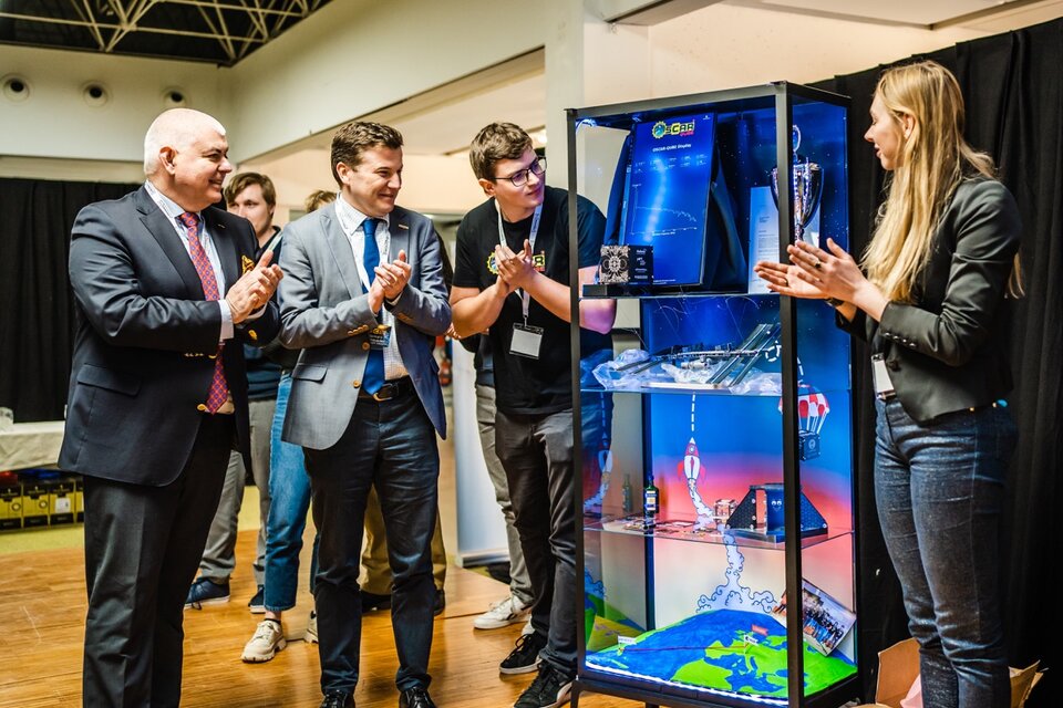 Hugo Marée, Head of the ESA Education Office and Bernard Vanheusden, Rector and Vice Chancellor of Univeristy of Hasselt watch eagerly with students as  the space-flown hardware comes to life once again in the display case. 
