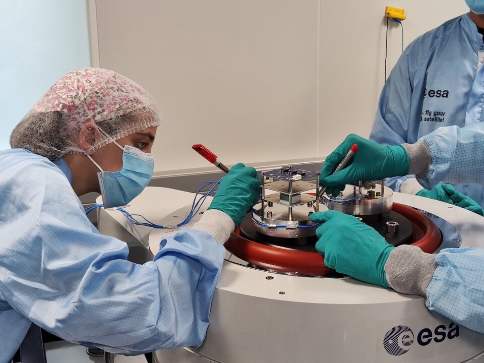 Students from the CubeSat Summer School 2022 while preparing a Vibration Test in the CubeSat Support Facility.