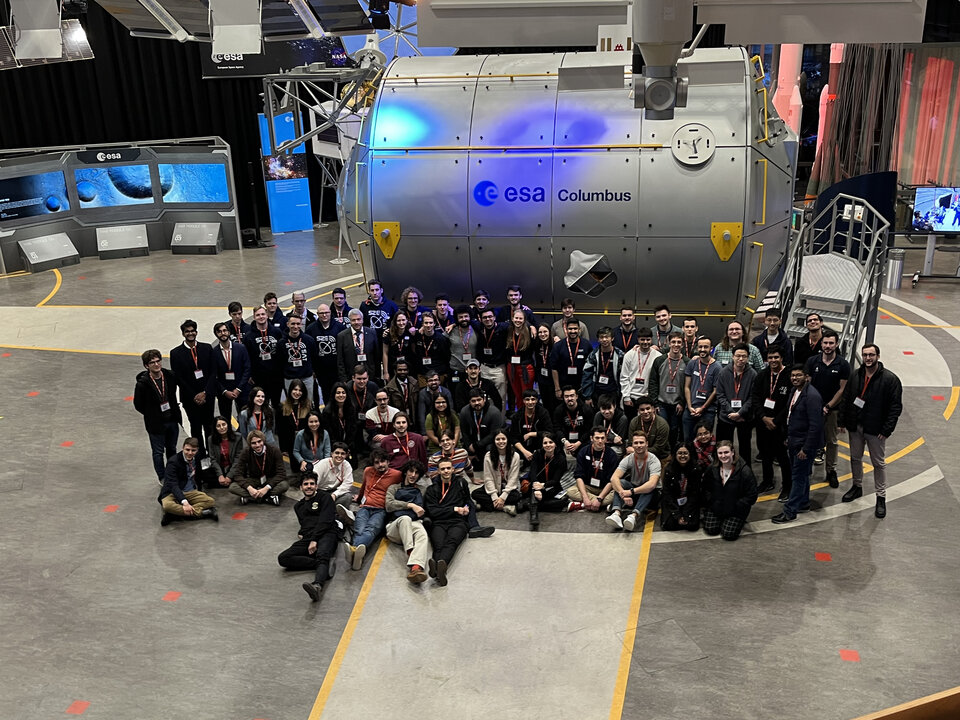Group picture of all the teams participating in the Fly Your Satellite! 4 Selection Workshop in front of ESA's Columbus Module mock-up