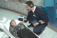 Medical assistant takes instruction from remote doctor