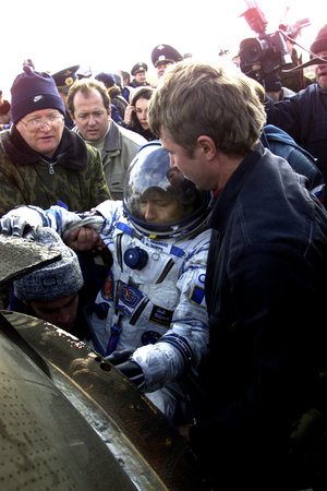 Claudie is helped out of the Soyuz