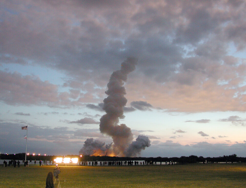 A trail of smoke marks the path of the Space Shuttle Colombia