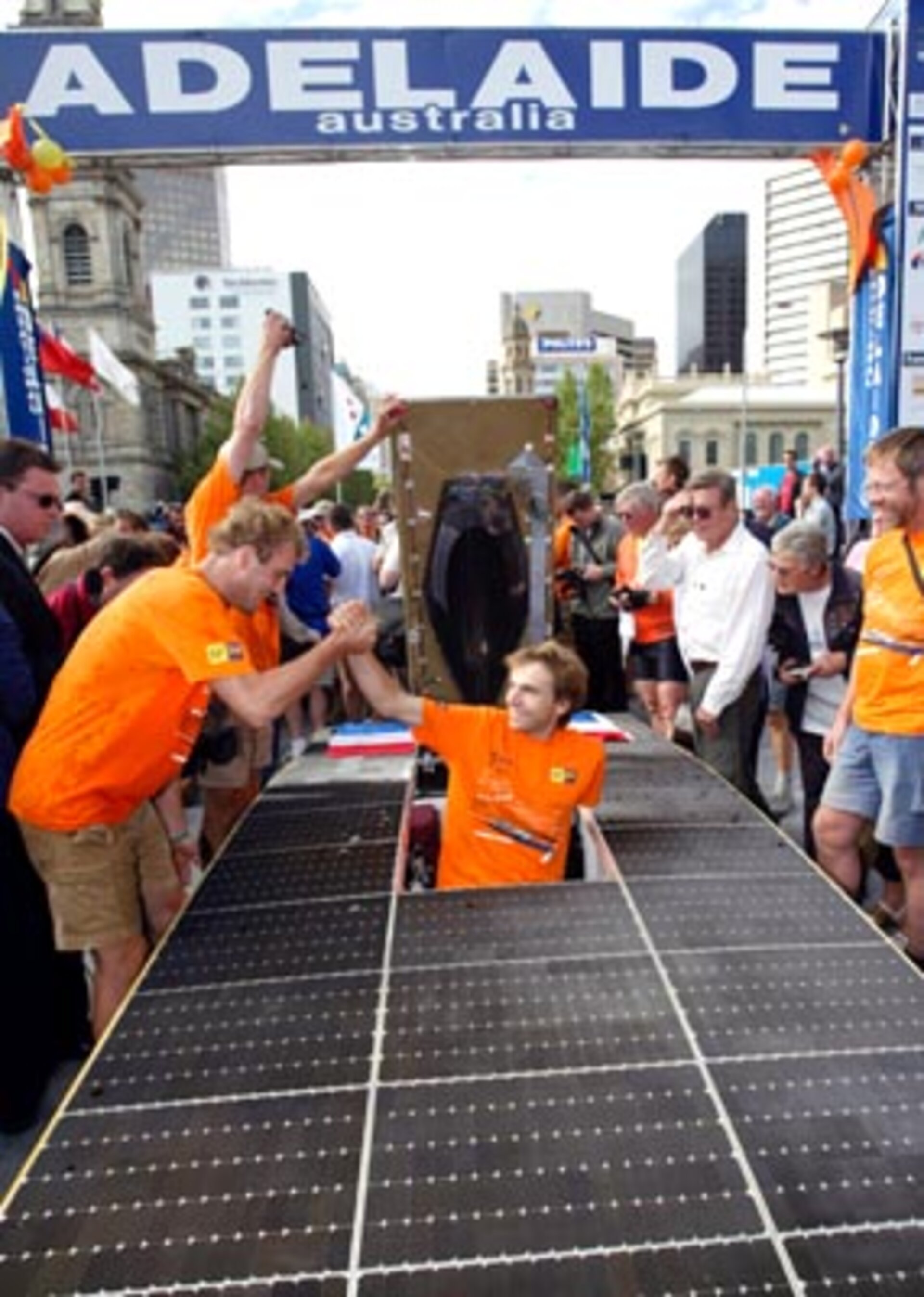 Mark Olsthoorn is helped from the team's car Nuna II after winning the World Solar Challenge