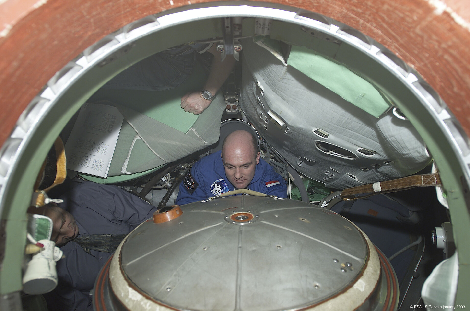André Kuipers seated inside the Soyuz simulator