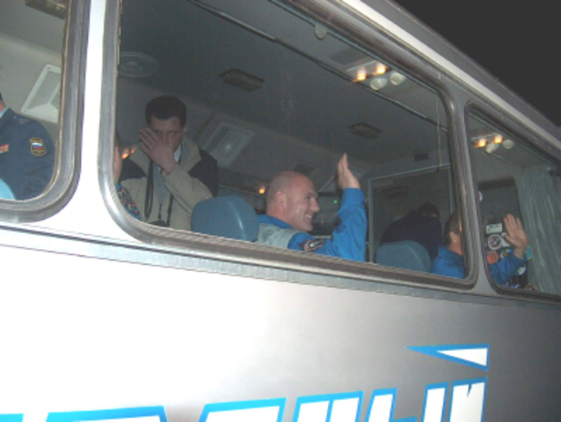 A smiling André Kuipers on the bus after leaving the Kosmonavt Hotel in Baikonour