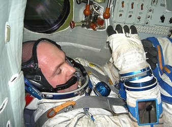 Putting on the gloves in Soyuz, ready for the final exam