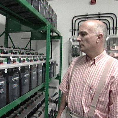 Antonio Lobato, beside some of the 750 stand-by  batteries to power the station if required