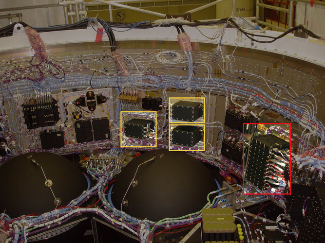 The Monitoring and Safing Unit (red) and Fault Tolerant Computer electronic boxes (yellow) inside the ATV's avionics bay