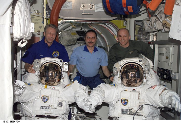 Expedition 13 with two American spacesuits in the Quest Airlock
